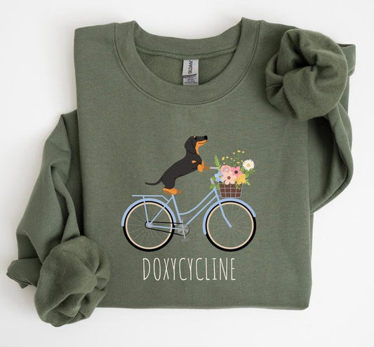 Doxycycline Pharmacy Pun Sweatshirt, Dachshund on Bicycle