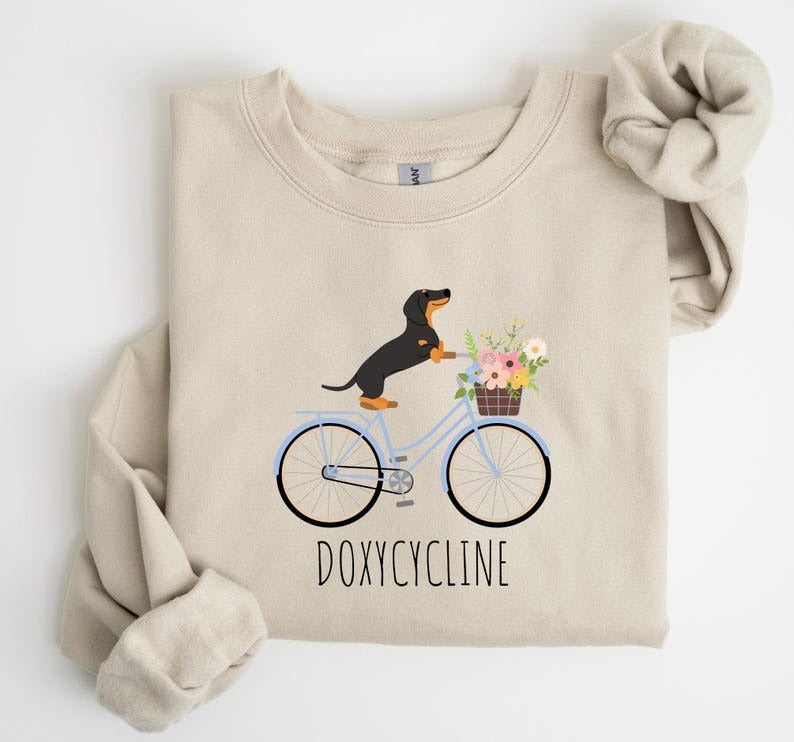 Doxycycline Pharmacy Pun Sweatshirt, Dachshund on Bicycle